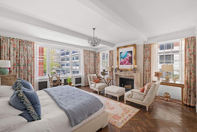 bedroom with beam ceiling, a notable chandelier, multiple windows, and a fireplace