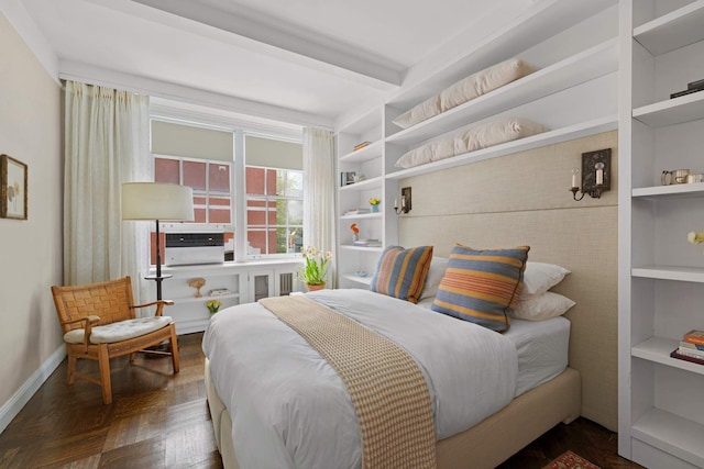 bedroom with beam ceiling and baseboards