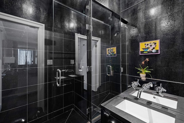 bathroom featuring a stall shower, vanity, and tile walls