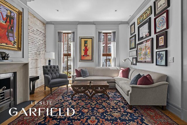 living room with ornamental molding and parquet floors