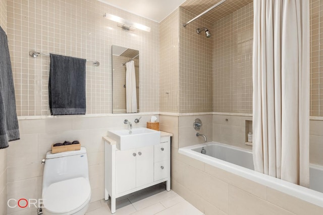 full bathroom featuring tile walls, vanity, toilet, shower / bathtub combination with curtain, and tile patterned floors