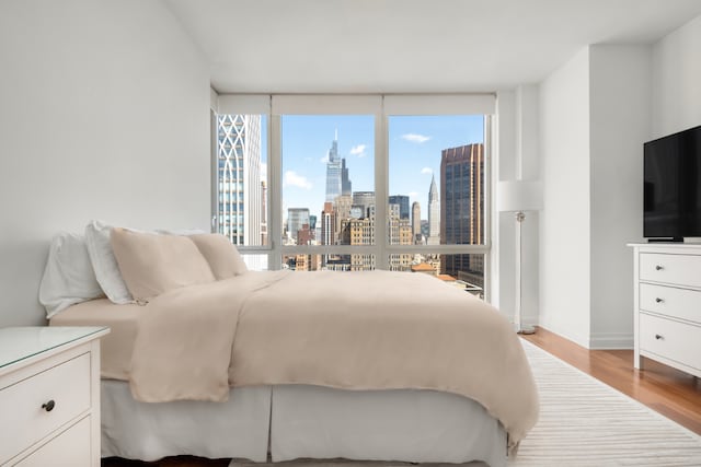 bedroom featuring light wood-type flooring and multiple windows