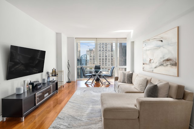 living room featuring floor to ceiling windows and hardwood / wood-style flooring