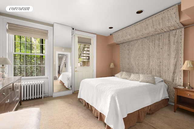 bedroom featuring radiator heating unit, carpet flooring, and visible vents