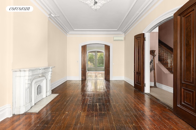 unfurnished living room featuring stairway, visible vents, arched walkways, and wood-type flooring