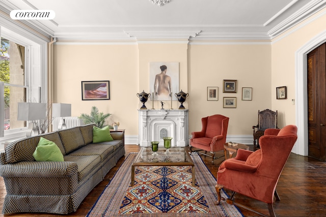 living area featuring hardwood / wood-style flooring, visible vents, and ornamental molding