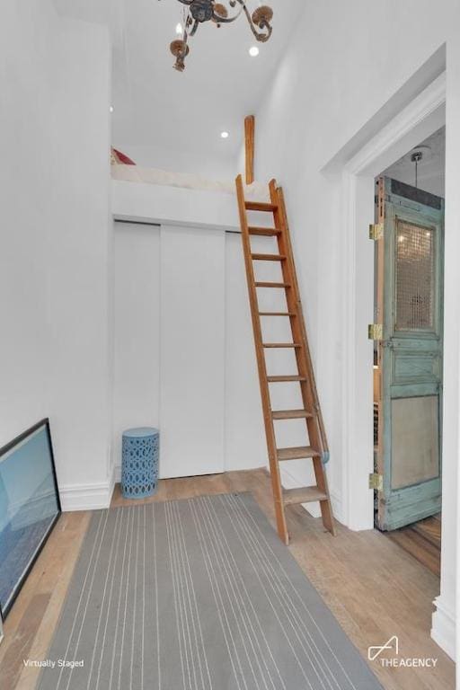 basement with hardwood / wood-style flooring and a chandelier