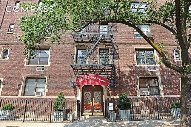 view of building exterior featuring cooling unit and fence