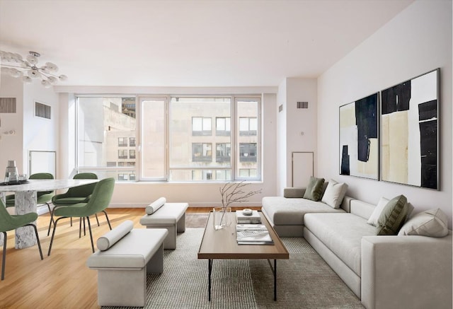 living room with ceiling fan and light hardwood / wood-style flooring