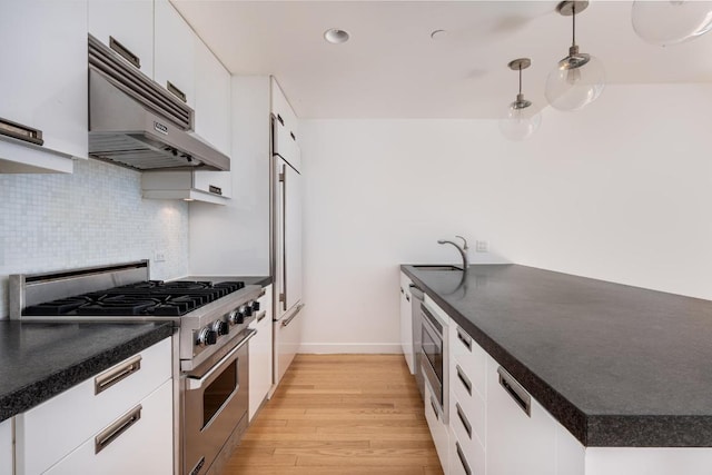 kitchen with stainless steel appliances, light hardwood / wood-style flooring, white cabinets, and hanging light fixtures