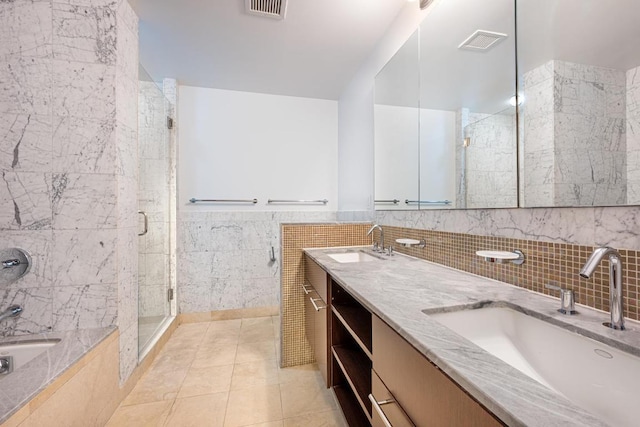 bathroom with tile walls, walk in shower, vanity, and tile patterned flooring