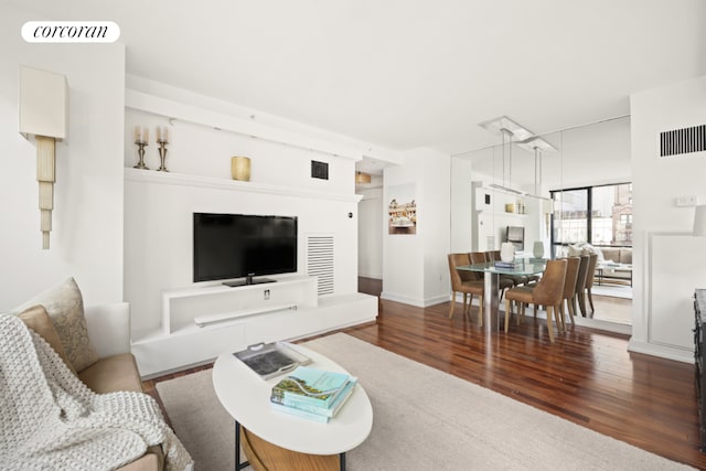 living room with dark hardwood / wood-style flooring