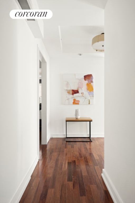 corridor with dark hardwood / wood-style floors