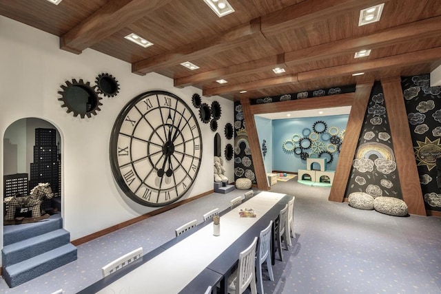 interior space with beamed ceiling, carpet flooring, and wooden ceiling