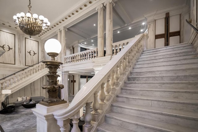 stairs with crown molding and a chandelier