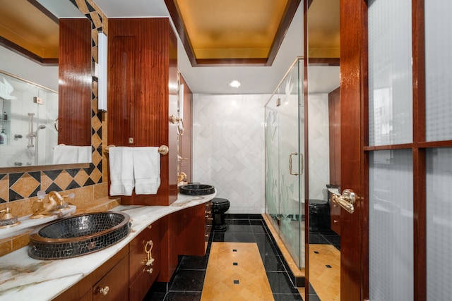 bathroom with tile patterned floors, vanity, backsplash, a raised ceiling, and a shower with shower door