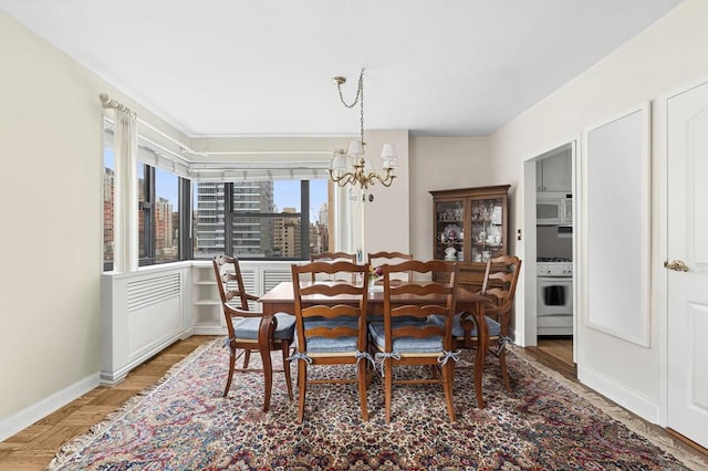 dining room with an inviting chandelier and wood-type flooring