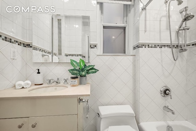 full bathroom with toilet, tasteful backsplash, tiled shower / bath, tile walls, and vanity