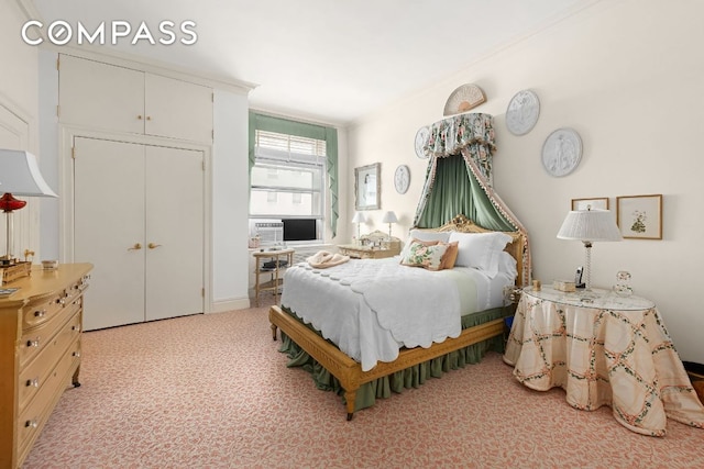 bedroom featuring crown molding, light carpet, and a closet