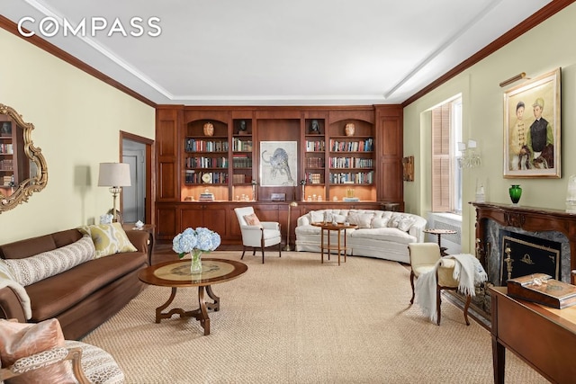 living area featuring light carpet, crown molding, a premium fireplace, and built in shelves