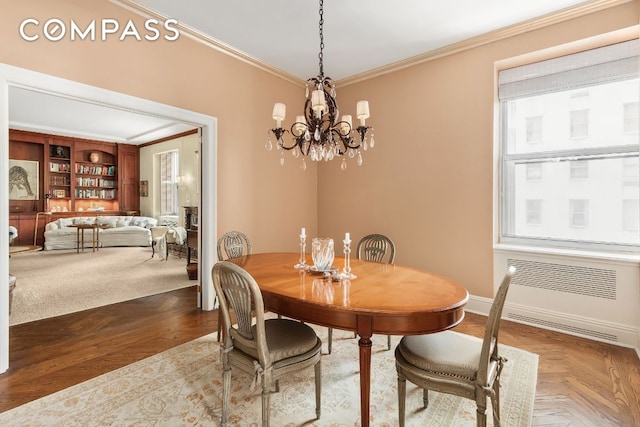 dining room featuring crown molding, parquet flooring, radiator, and a chandelier