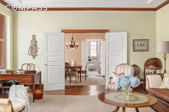 living room with ornamental molding, hardwood / wood-style floors, and a notable chandelier