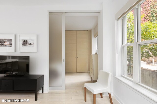 interior space with light wood finished floors and baseboards