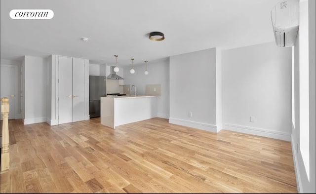 unfurnished living room with sink and light wood-type flooring