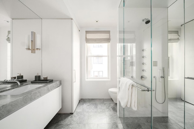 full bath featuring a shower stall, vanity, marble finish floor, and toilet