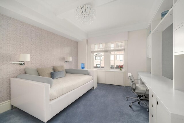 bedroom featuring an inviting chandelier, beam ceiling, light colored carpet, and crown molding