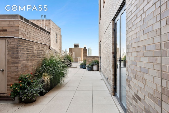 view of home's exterior featuring brick siding and a patio area