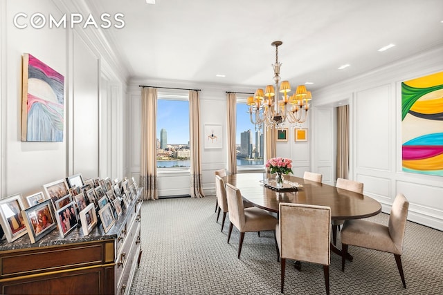 435 E 52nd St Unit 16C2, New York City, NY 10022 - dining room with a decorative wall, light carpet, a chandelier, crown molding, and a water view