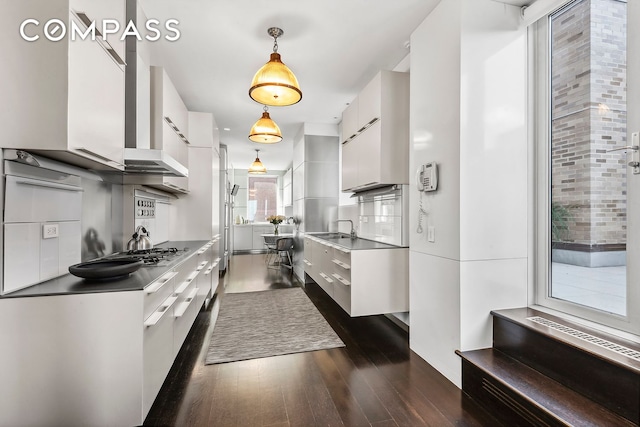 435 E 52nd St Unit 16C2, New York City, NY 10022 - kitchen featuring white cabinetry, dark wood finished floors, and modern cabinets
