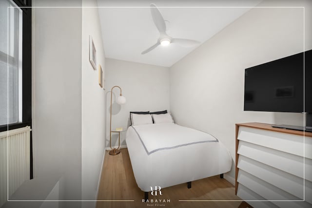 bedroom with ceiling fan and hardwood / wood-style flooring