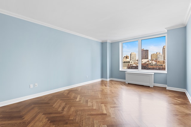 empty room featuring crown molding, baseboards, and a city view