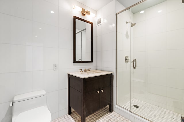 bathroom featuring visible vents, a stall shower, toilet, and tile walls