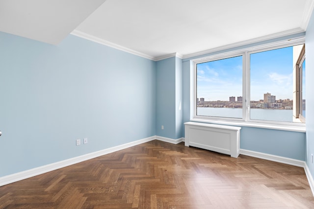 spare room featuring baseboards and ornamental molding