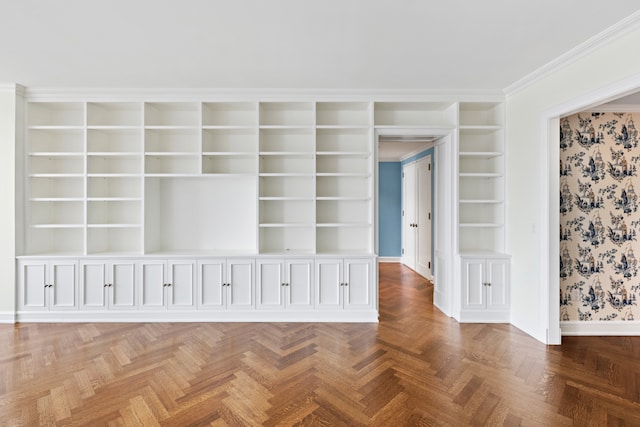 spare room featuring baseboards, built in shelves, wallpapered walls, and ornamental molding