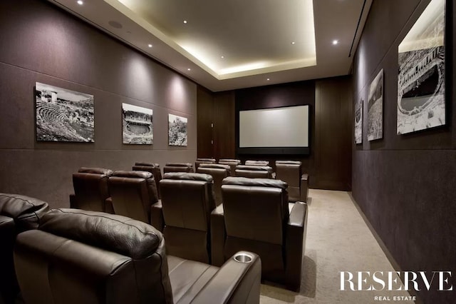 home theater featuring a raised ceiling, light carpet, and recessed lighting