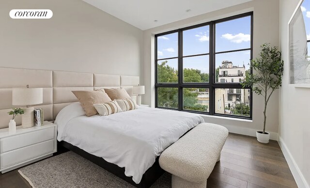 bedroom with dark hardwood / wood-style flooring and vaulted ceiling