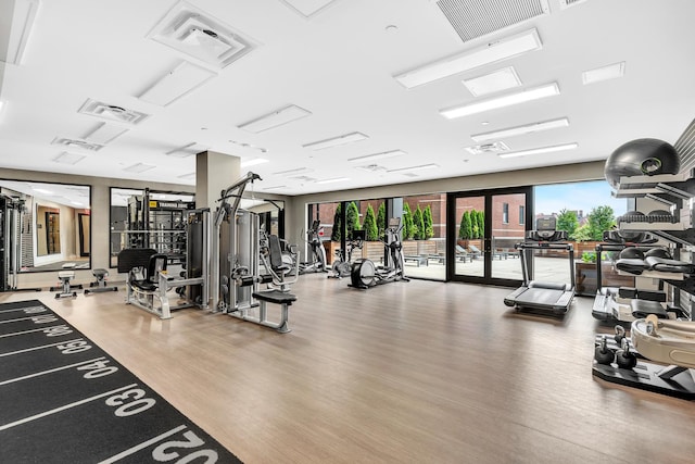 workout area with wood finished floors