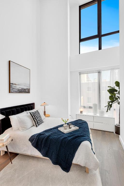 bedroom featuring a high ceiling and hardwood / wood-style floors