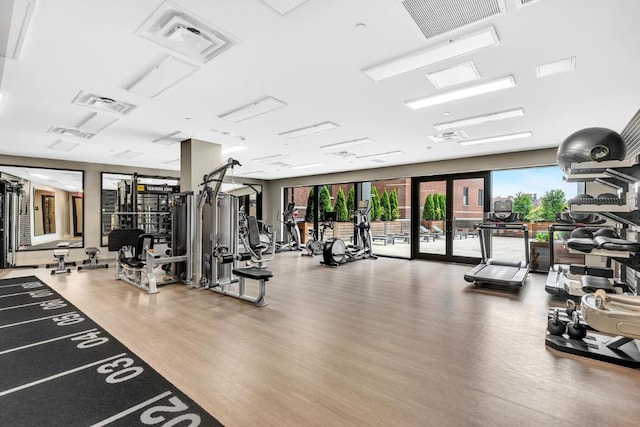 workout area with hardwood / wood-style flooring