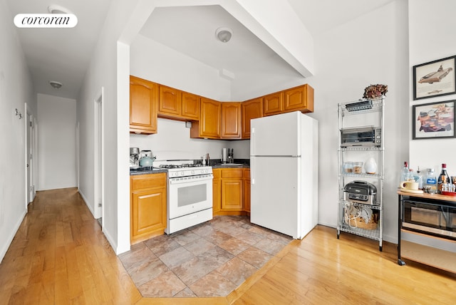 kitchen featuring white appliances and light wood-type flooring