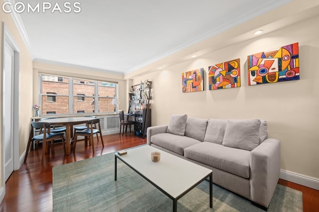 living room with dark wood-type flooring and crown molding