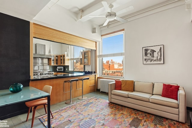 living room with ceiling fan, tile patterned floors, and radiator heating unit