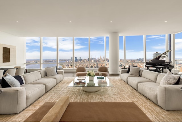 living room with a wall of windows and a city view