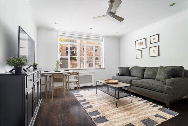 living room with ceiling fan, dark wood-type flooring, and ornamental molding