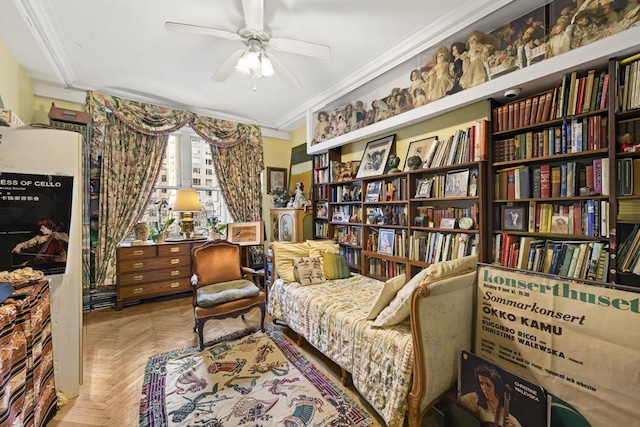 living area with ceiling fan, light parquet flooring, and crown molding