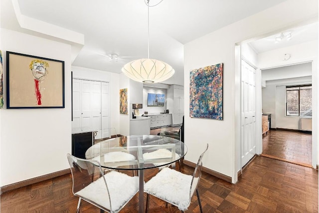 dining room with dark parquet flooring